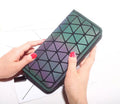Women's long geometric PU wallet with luminous zipper, 20cm x 10cm x 2cm, open to show card slots and coin pocket.