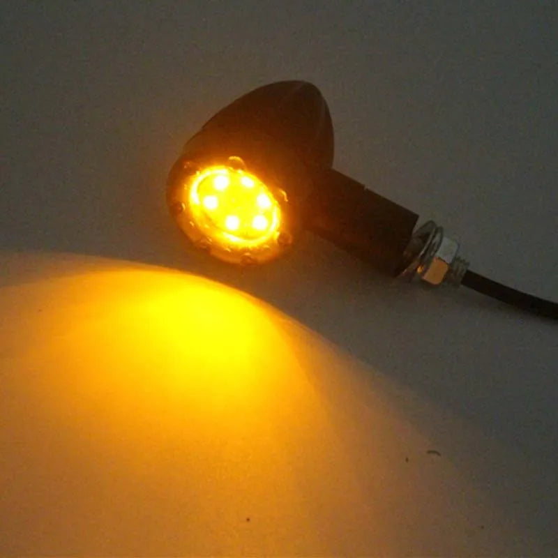 Pair of 6-LED motorcycle turn signals with smoke cover and black plastic housing, 8mm screw mount