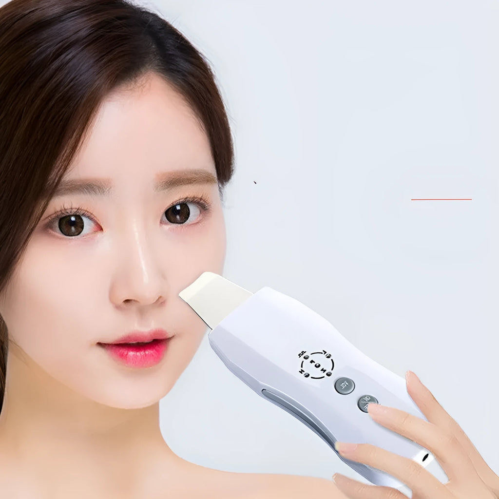 White ultrasonic facial cleanser with ABS body and stainless steel head on blue background