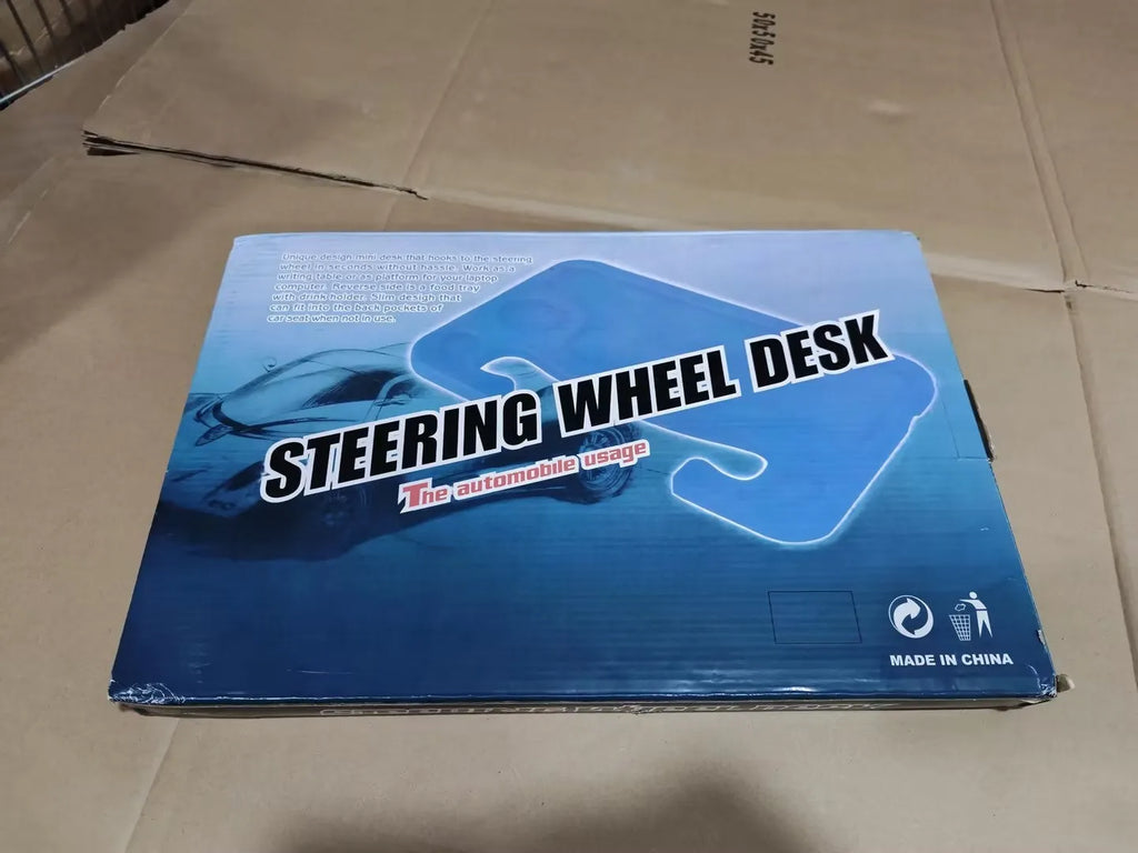 Large black HDPE car steering wheel tray measuring 42x28cm, placed over a steering wheel as a flat desk surface.