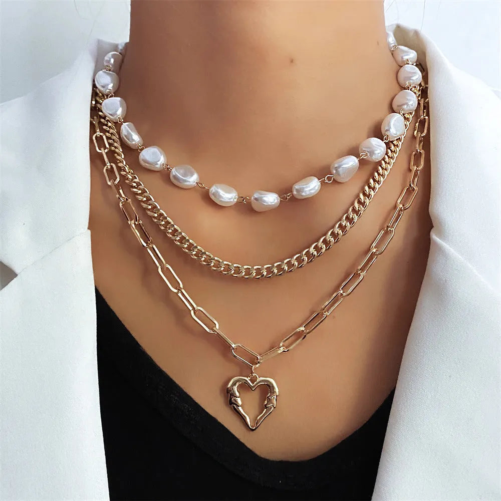 Gold tone heart-shaped pendant necklace with pearl chain, vintage love symbol jewellery