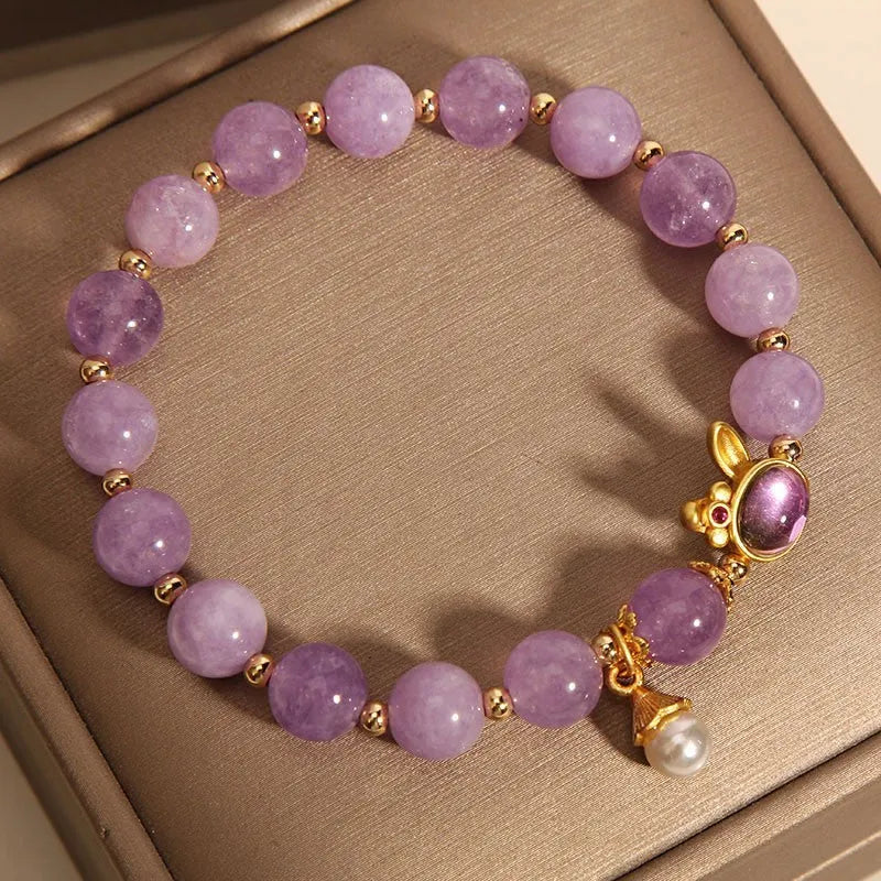 Purplish red jade rabbit hare head charm on a crystal Mori style bracelet.