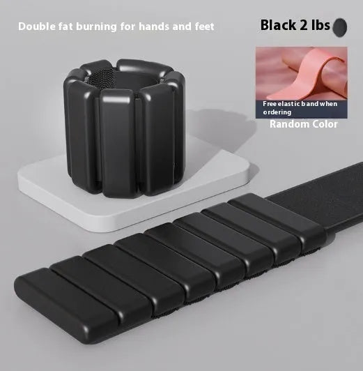 Silicone fitness bracelet with detachable weights and Velcro strap in black, blue, grey, or pink.