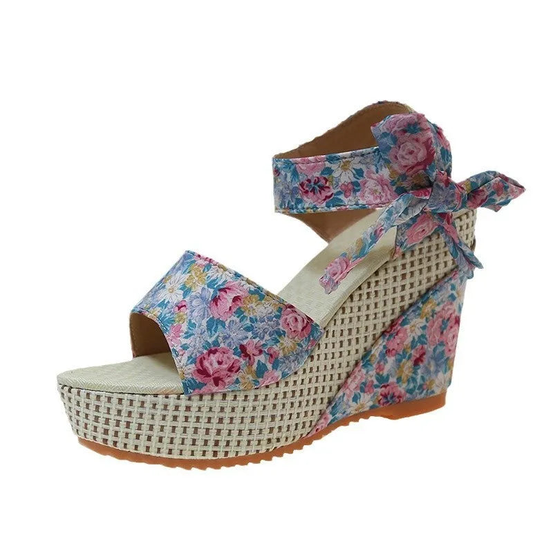 Women's floral wedge sandals with fish mouth peep toe and ankle strap buckle in pink, black, and blue patterns.