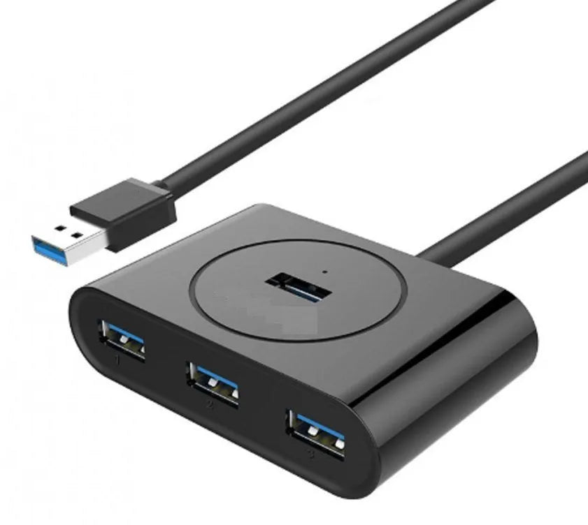 Deep black USB splitter with four ports, Micro USB power port, and indicator light on a desk