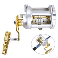 Silver metal sea fishing drum reel with CNC machined body, brass gears, star drag button, and large line spool