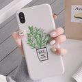 White silicone iPhone case with a detailed painted plant design on the back, showing the smooth texture and enclosed edges.