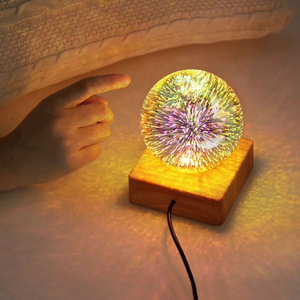 USB plug-in crystal ball night light displaying colourful firework pattern on a dark surface.