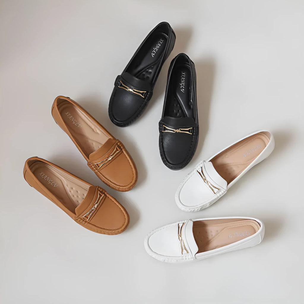 Black, white, and brown slip-on shoes with a round toe and a soft rubber sole for height increase