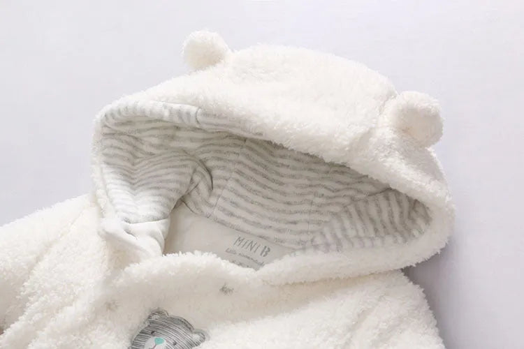 Baby cotton padded winter jumpsuit in marrón colour with long sleeves and feet coverings