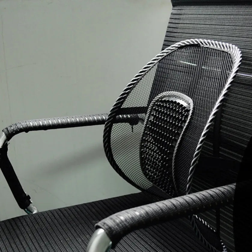 Black car lumbar support pillow with mesh cover on a car seat.