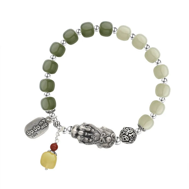 Retro women's silver coin bracelet with a natural Hetian jade stone.