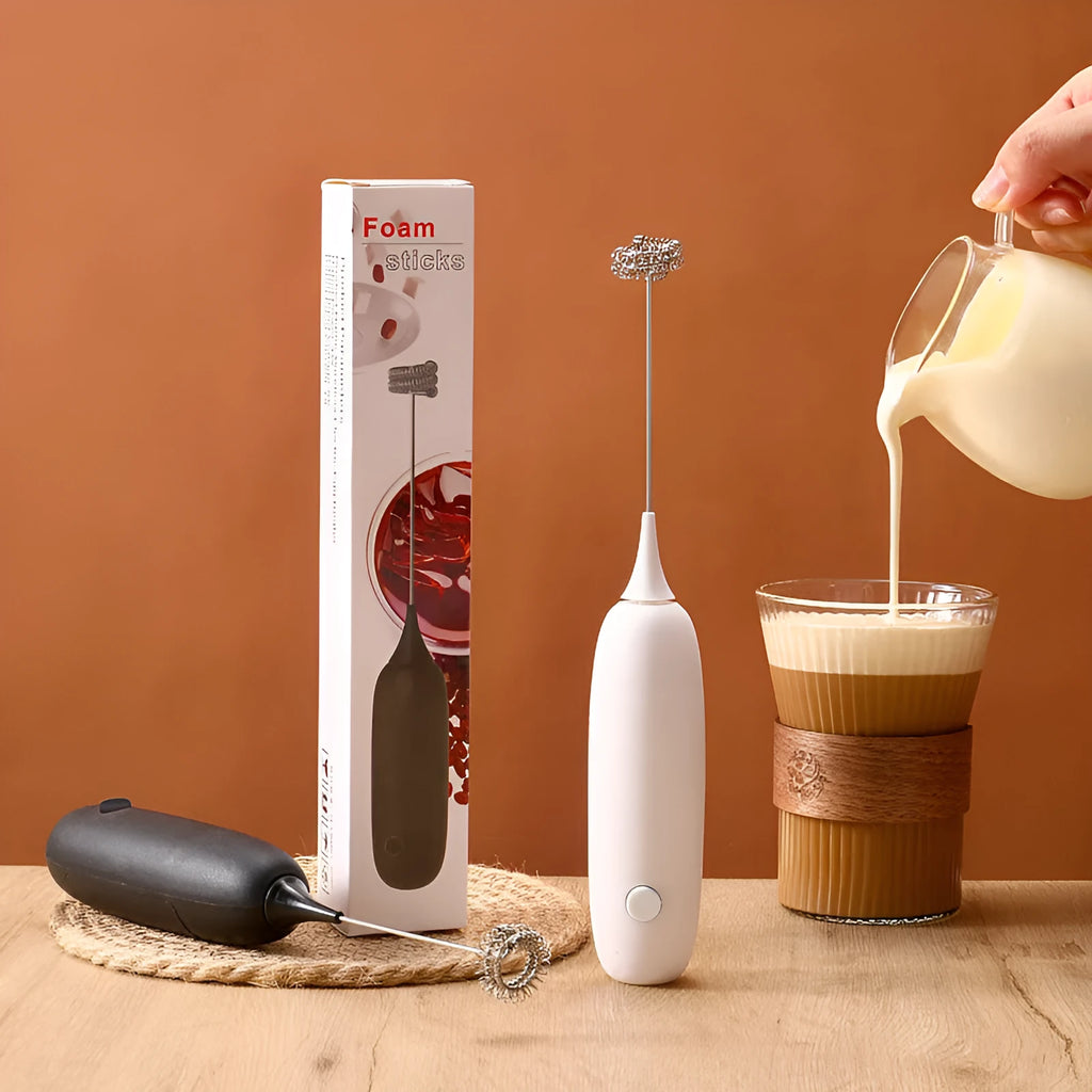 Black and white hand-held electric milk frother blender with modern design for coffee preparation