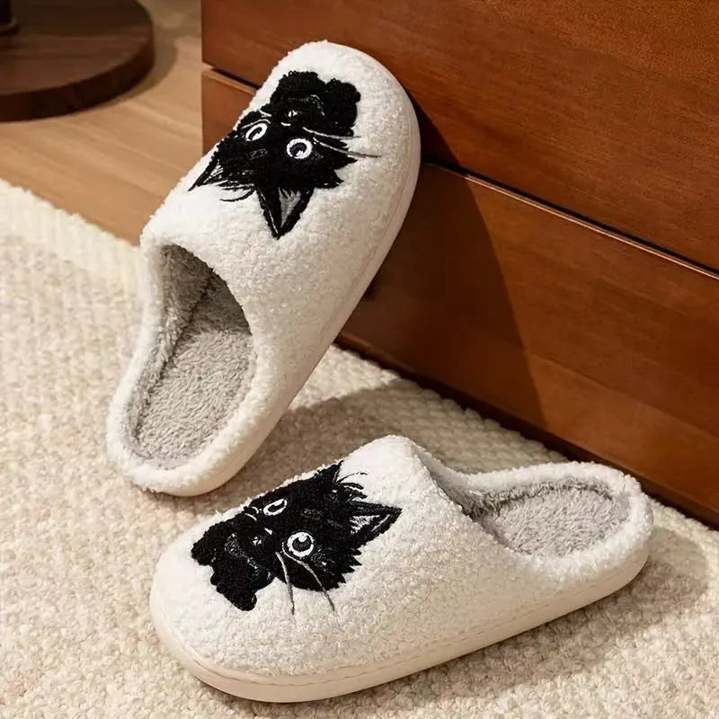 White plush slippers with a Black Beard Cat cartoon design on the toe.
