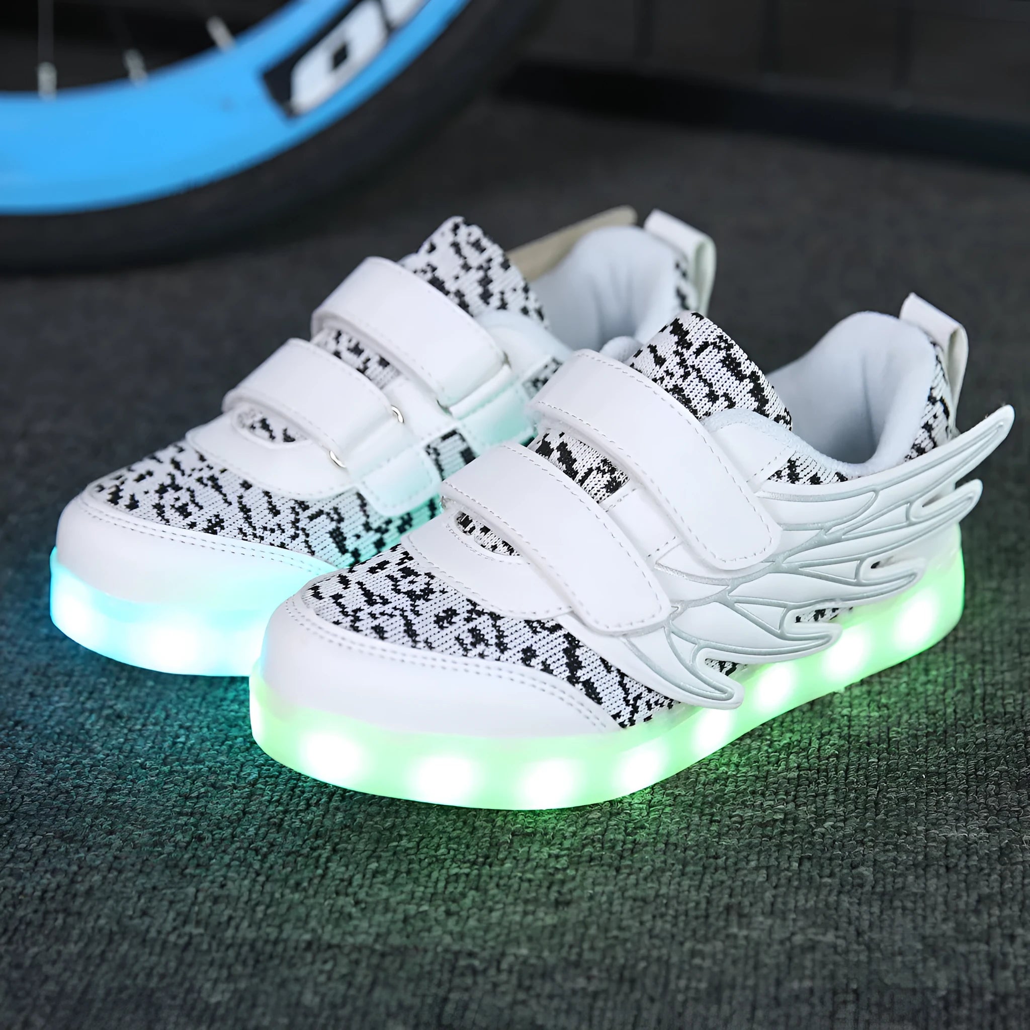Children's plum red and white LED light-up trainers with colourful wing designs and USB charging port.