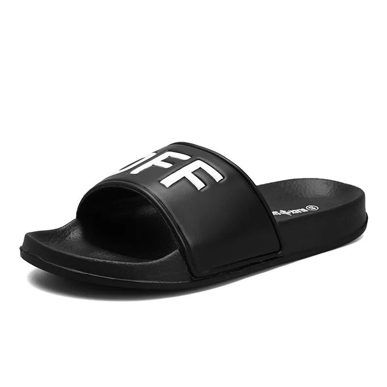 A pair of large black open-toe men's slippers with a rubber sole on a plain background.