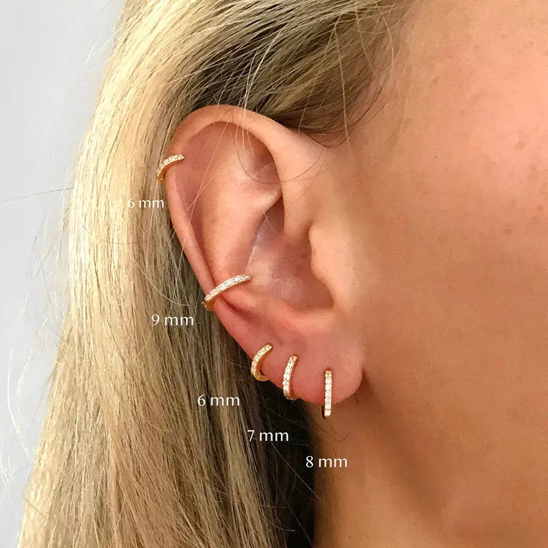 Gold, rose gold, and silver coloured perforated circle zircon stud earrings in various sizes from 5mm to 12mm diameter.