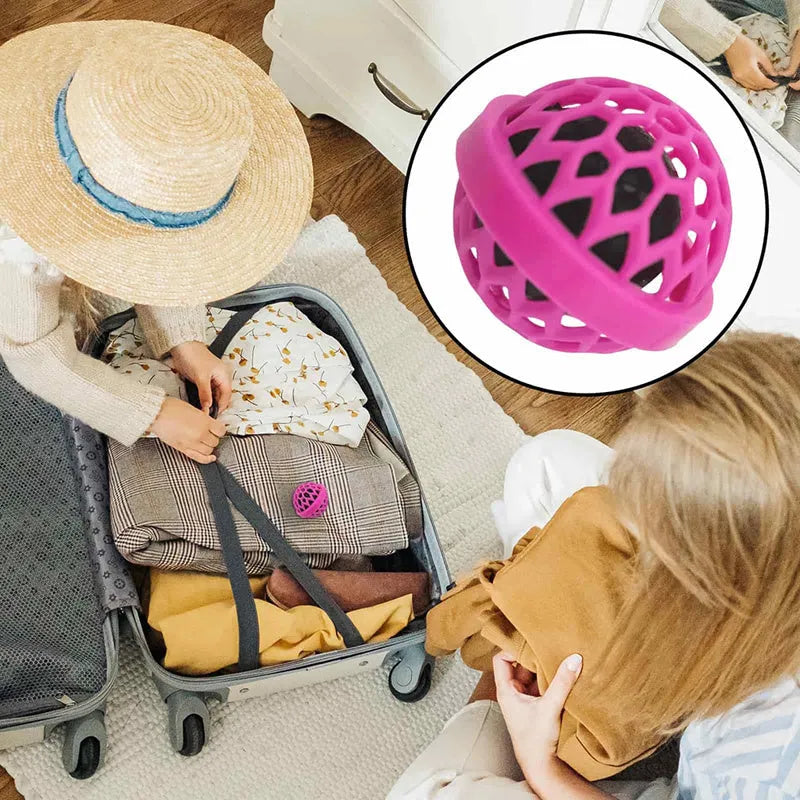 Reusable bag cleaning ball in pink colour on a clean surface