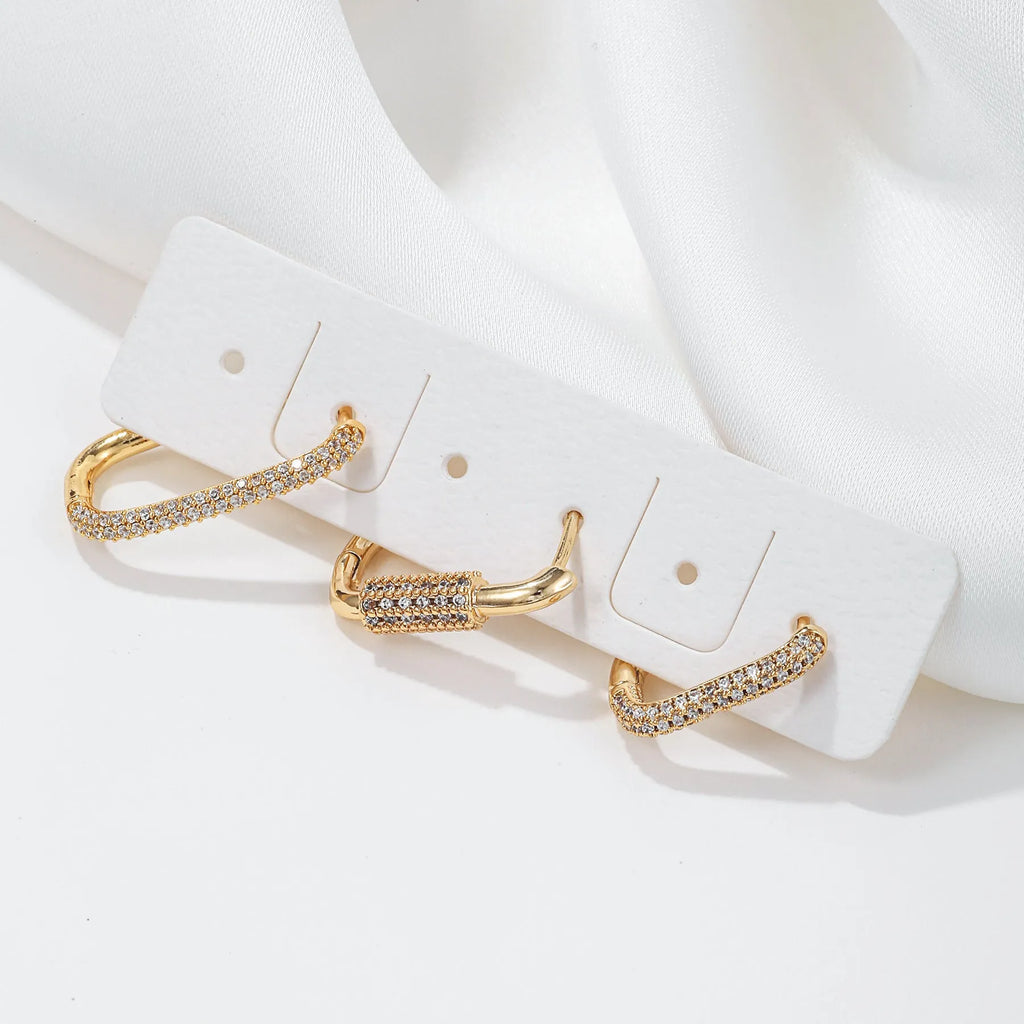 Geometric zircon ear clip set showing three square earrings with quadrilateral and ellipse designs