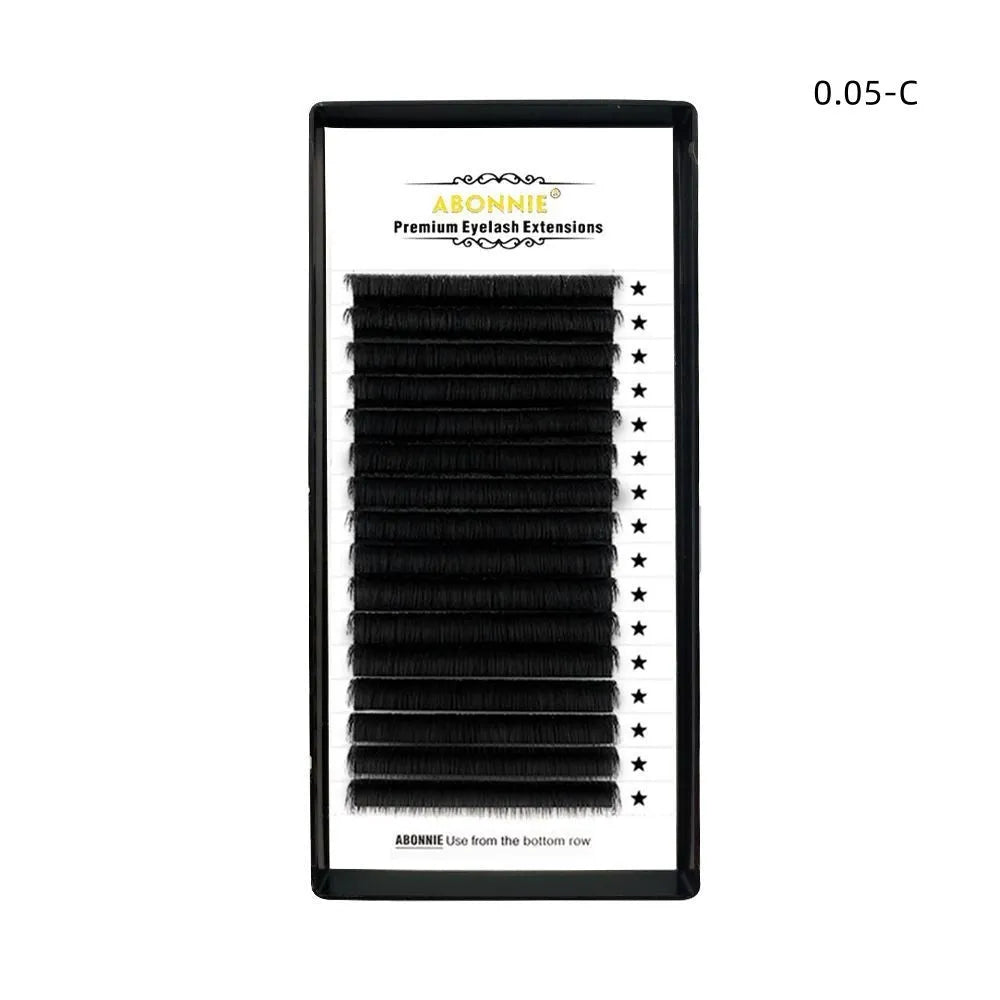 Pair of 16-row dense false eyelashes made from mink hair, showing matte round wool texture on a clear band.