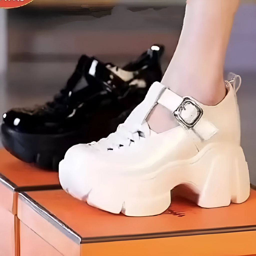 Women's black and white satin pumps with a chunky wedge heel and hollow-out detail.