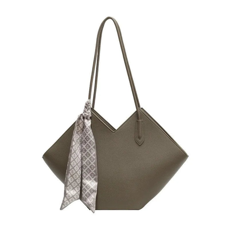 Large beige PU leather women's shoulder bag with adjustable straps on a white background.