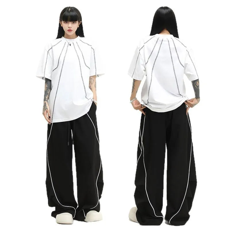 Black striped pleated hip-hop wide-leg sports pants on a hanger.