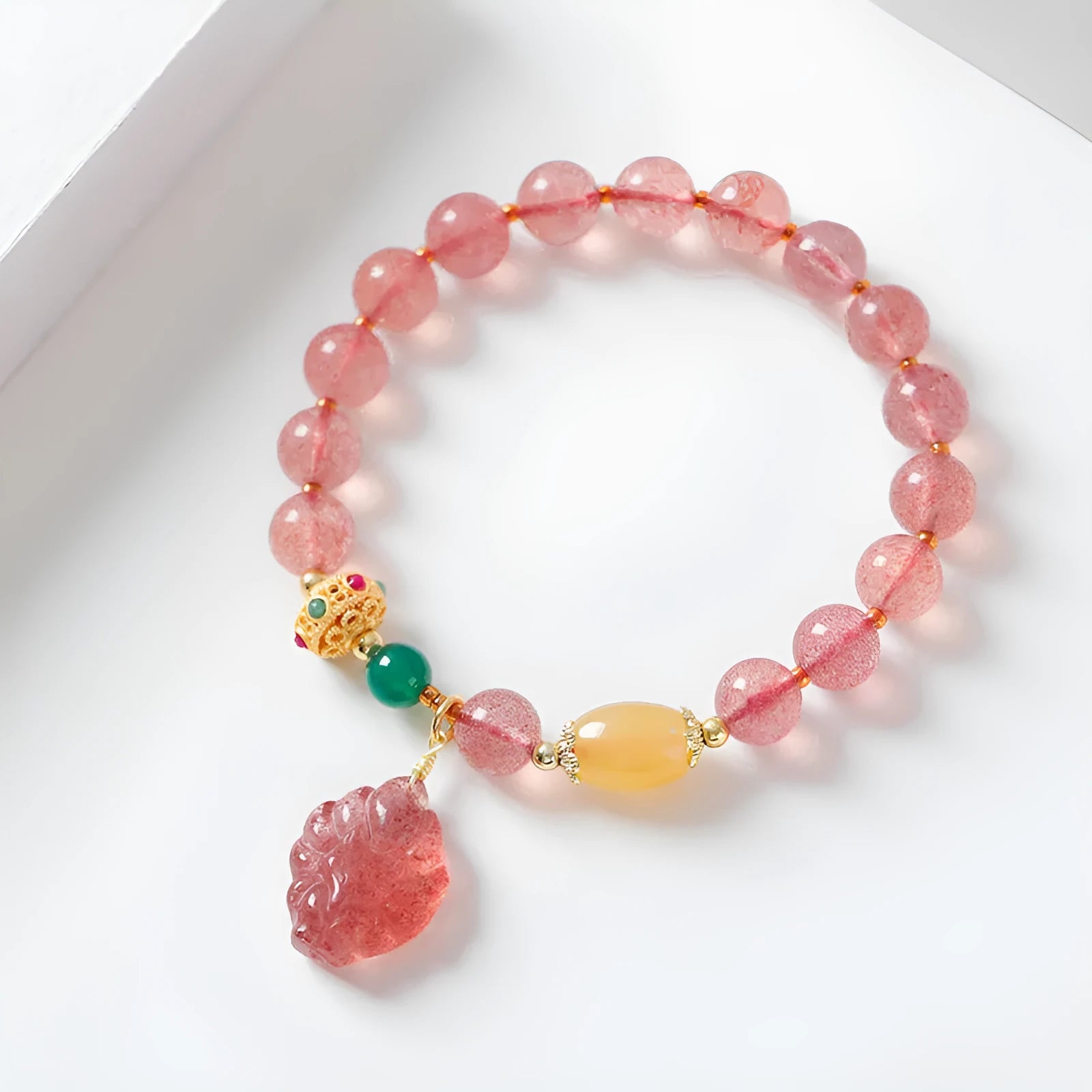Women's Nine Tail Fox style strawberry quartz crystal beaded bracelet on wrist