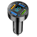 Black four-port car USB charger with LED digital display plugged into a vehicle socket.