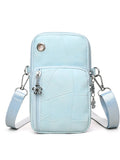 Mini cell phone bag vertical square PU leather crossbody with sandwich pocket in black on white background