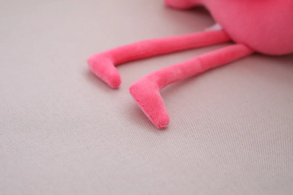 Pink flamingo plush toy with short plush fabric, filled with PP cotton, sitting on a surface