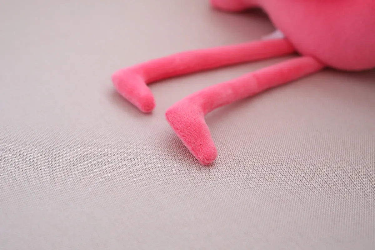 Pink flamingo plush toy with short plush fabric, filled with PP cotton, sitting on a surface