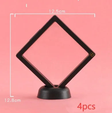 3D floating display case holding a coin suspended between transparent membrane sheets, black frame