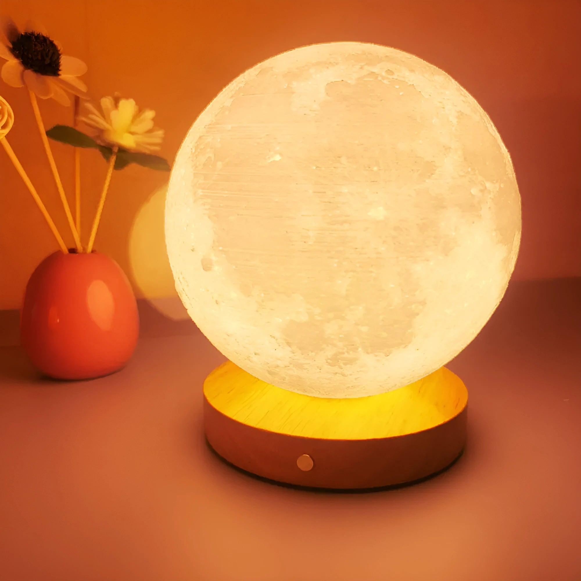 Rotating moon night lamp on a wooden base showing three colour light modes.
