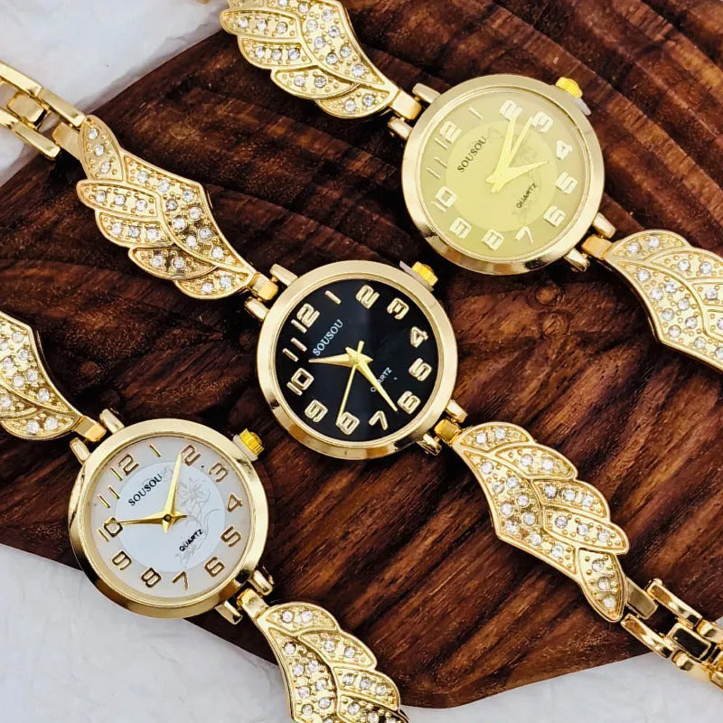 A stainless steel women's watch with a round dial on a metal strap, showing a gold-coloured face.