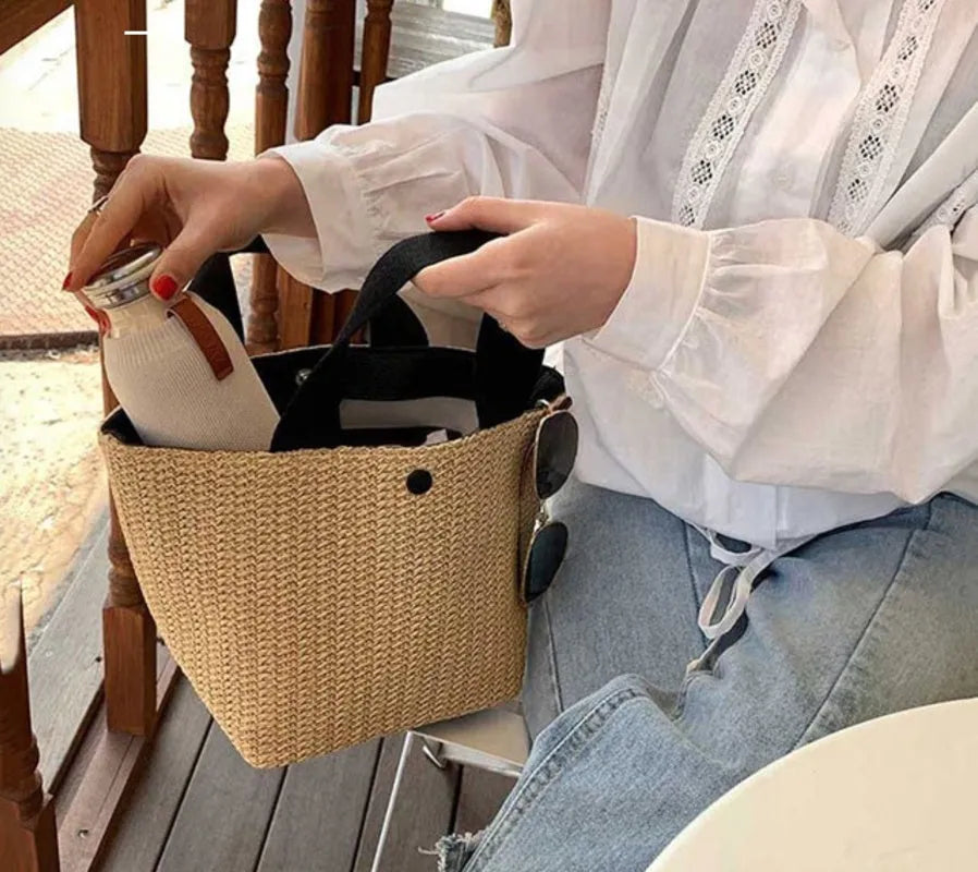 Casual rattan straw shoulder bag in black, bucket shape with shoulder strap