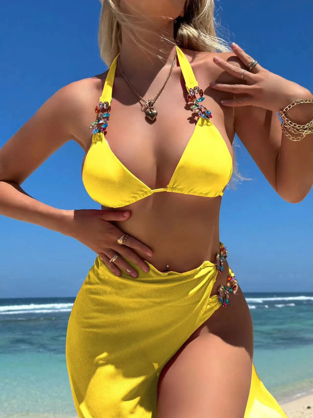 Women's three-piece swimsuit set with bikini top, pants, and matching skirt in solid colour