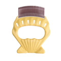 Shell-shaped plastic pet grooming comb with bent wire bristles in green, orange, or purple colours.
