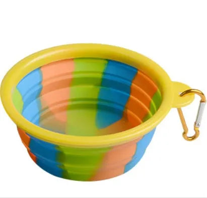Collapsible silicone dog bowl in camouflage pattern folded flat on green surface