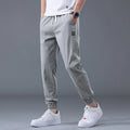 Men's casual loose drawstring pants in black, tapered high-waist solid colour cotton-blend trousers