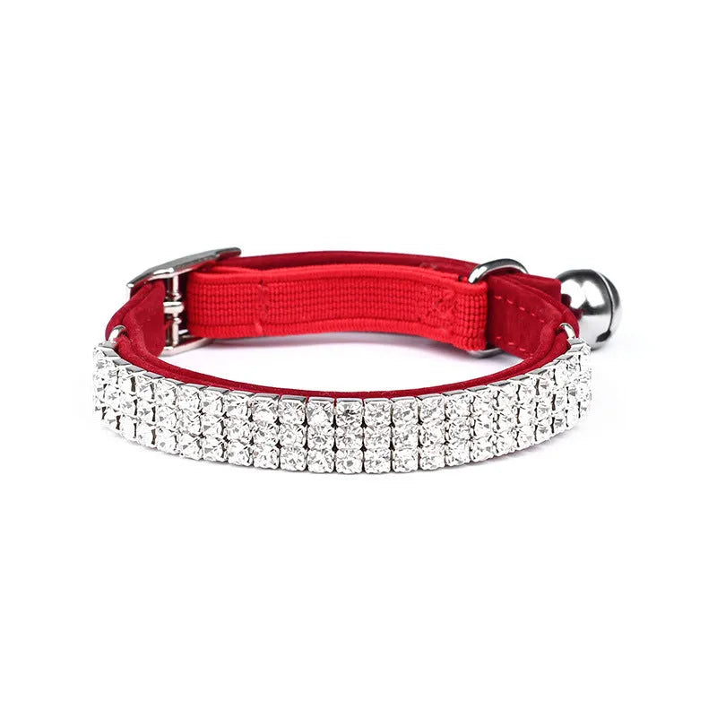 Red velvet cat collar with rhinestones, showing adjustable buckle set to a 25cm length.