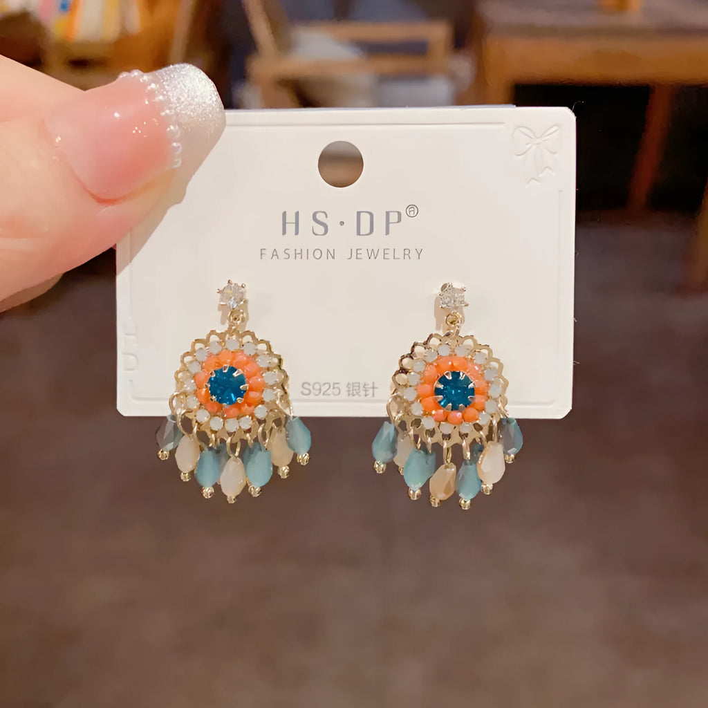 Women's round crystal tassel earrings with embedded diamonds in blue and purple geometric designs