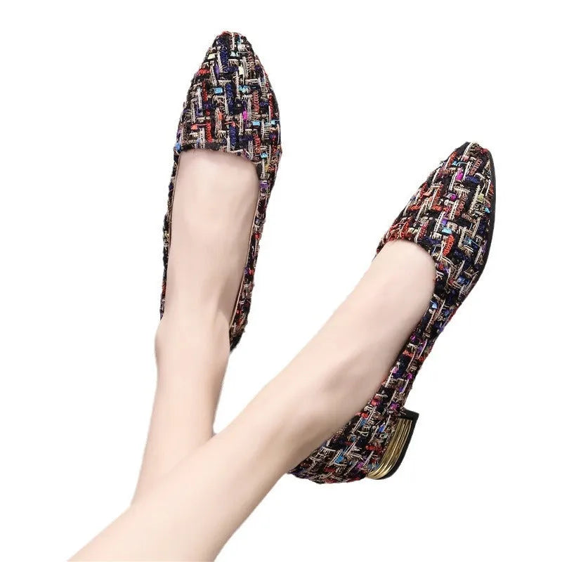 Women's black canvas casual flats with pointed toe and low-cut design on flat rubber sole