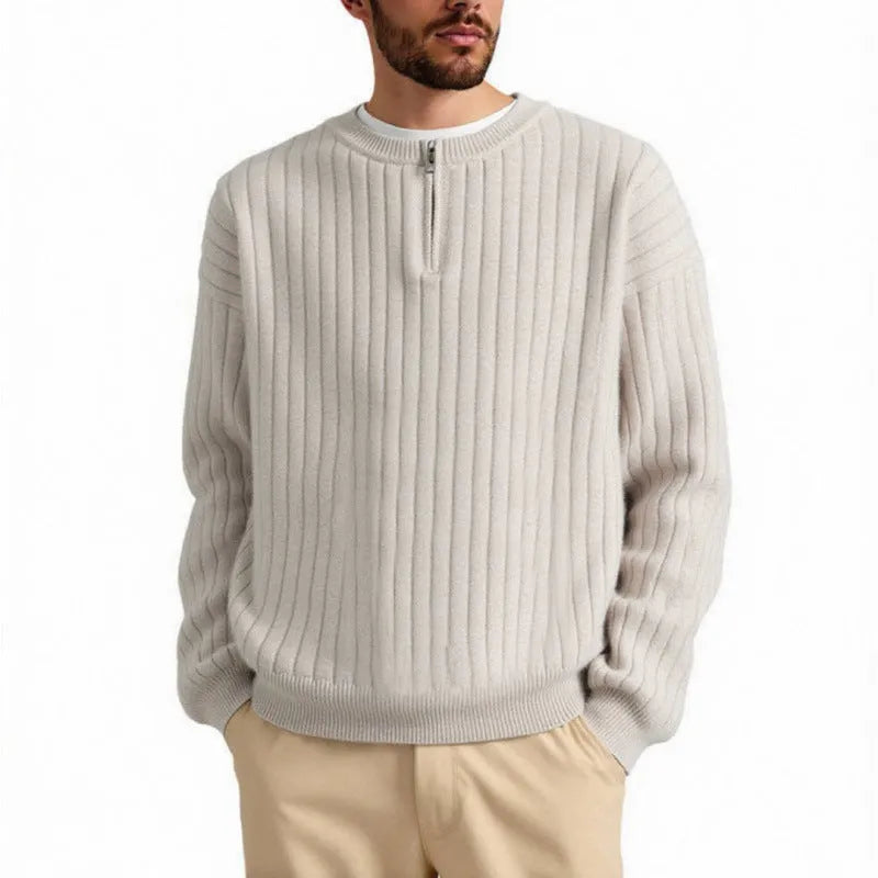 Man wearing a grey half-zip loose fit textured knit sweater