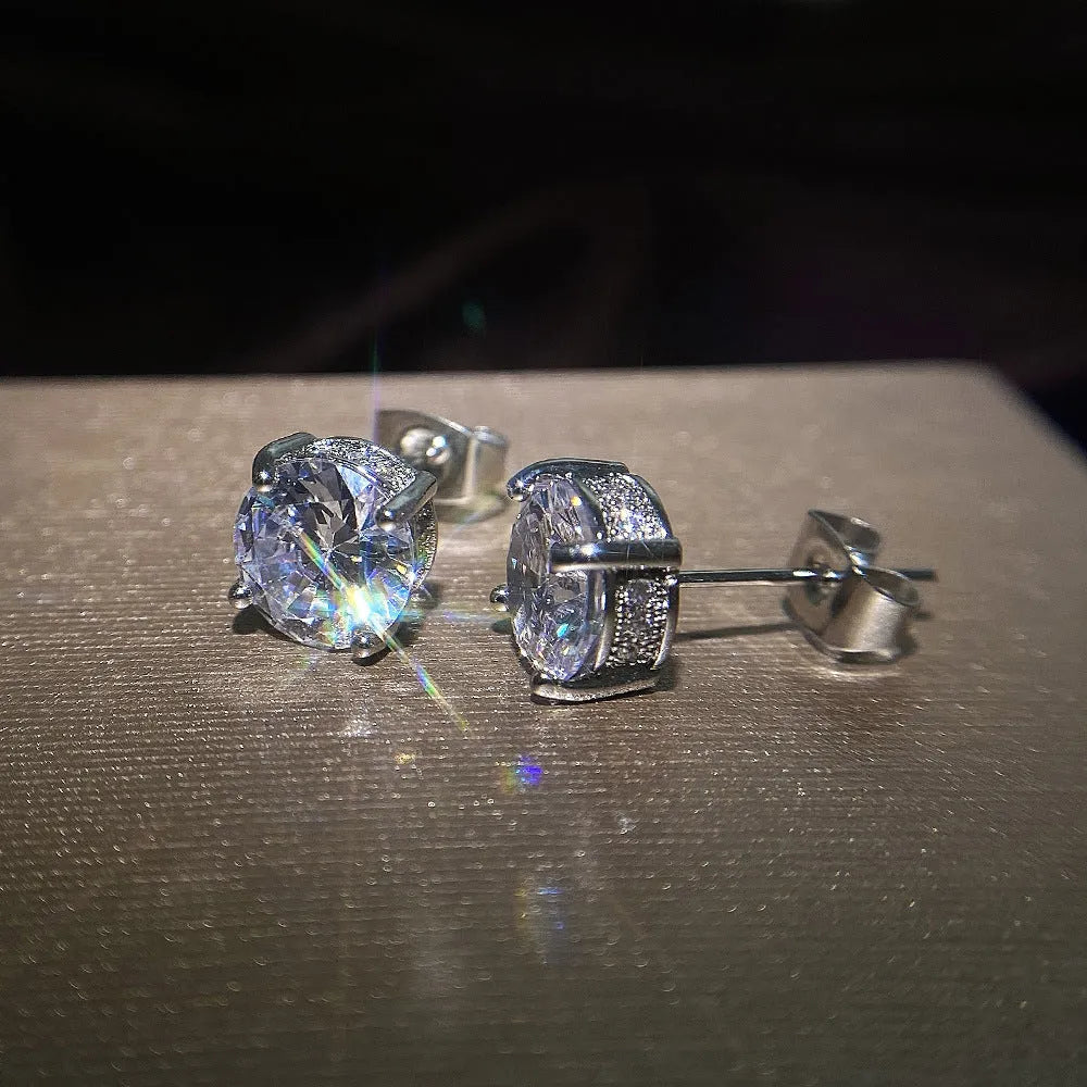 Women's round white zircon stud earrings with copper geometric round shape on display