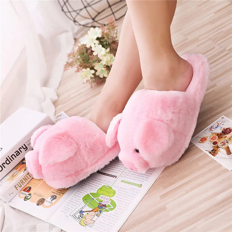Pink pig-shaped plush floor slippers with PP cotton filling on a plain background