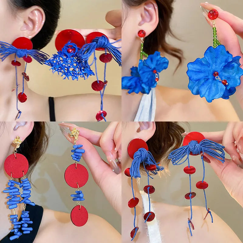 Geometric women's earrings made from blue and silver cloth with round design elements.