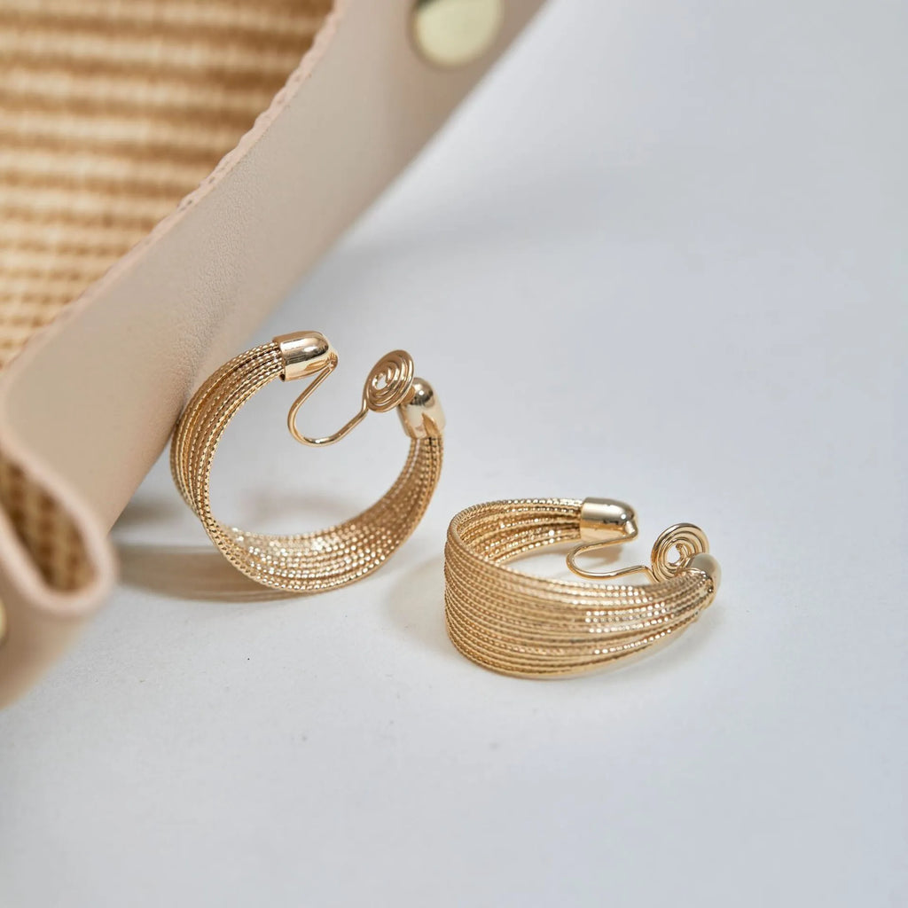 Geometric copper earrings with electroplated gold or silver finish showing stud and clip style options