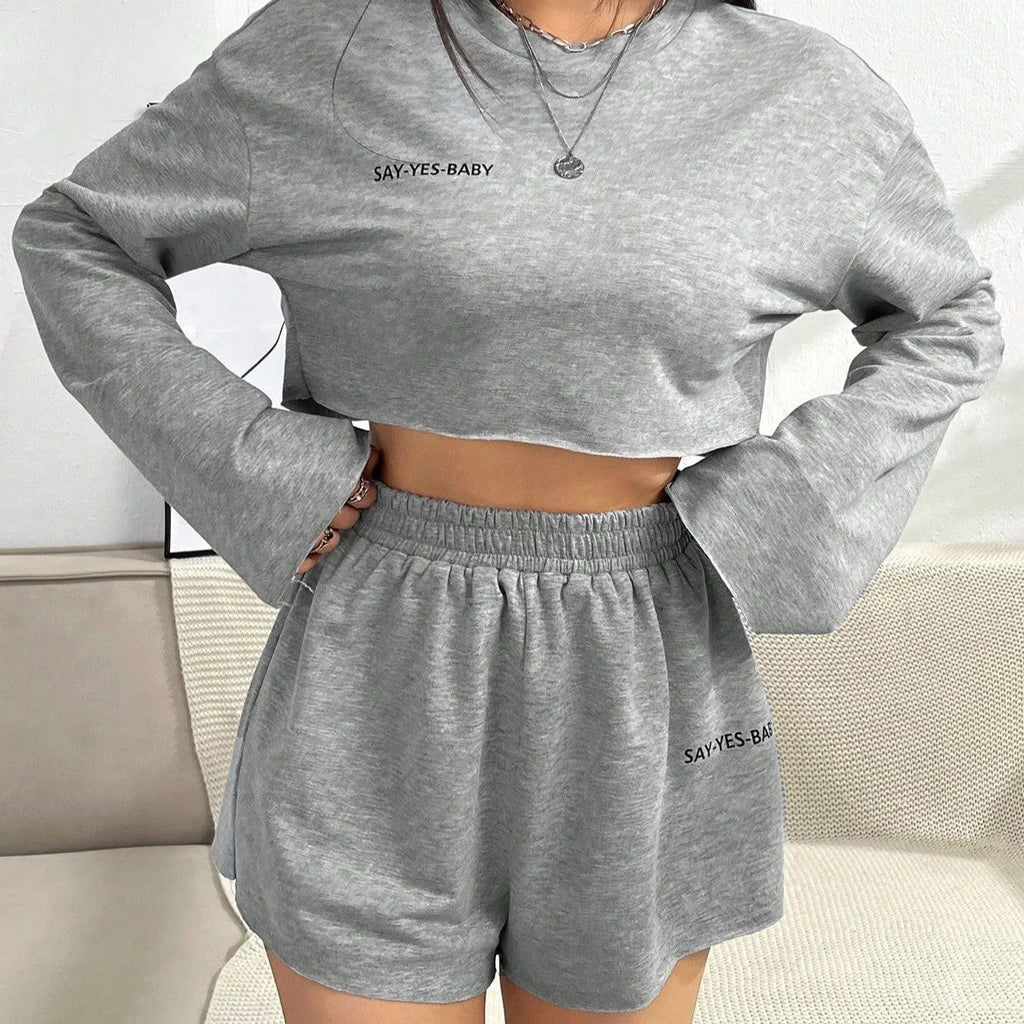 Grey women's long-sleeved T-shirt and matching shorts polyester suit set laid flat.