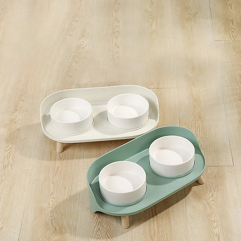 Green and white adjustable tilted pet feeding bowl with dual food and water compartments for cats and dogs